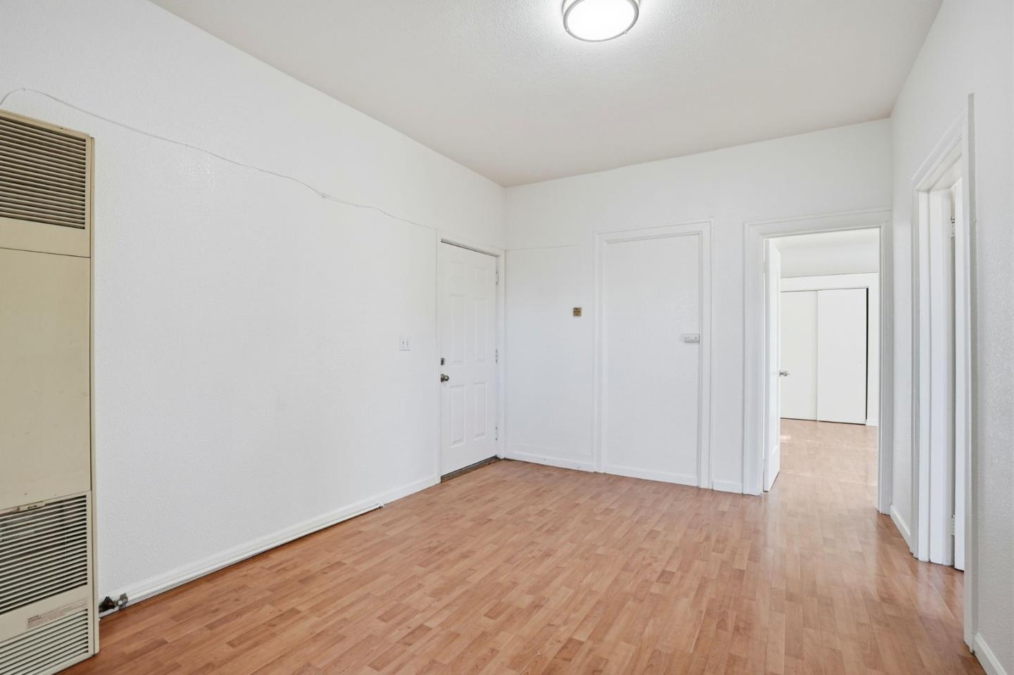 603 Madison Street Oakland, CA 94607 - Photo 7 of 43 a view of an empty room with wooden floor