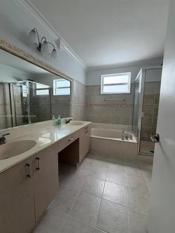 a bathroom with a sink a toilet a mirror and bathtub