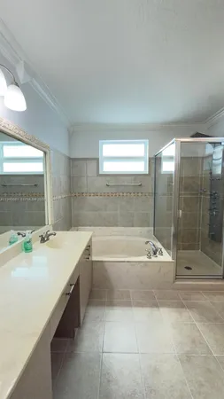 a bathroom with a bathtub sink and mirror