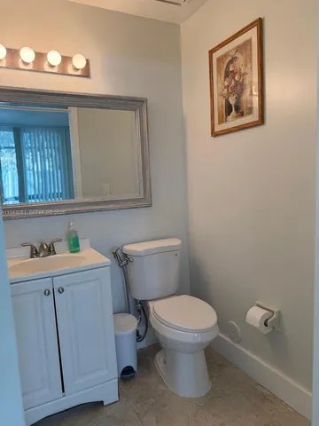 a white toilet sitting next to a bathroom sink