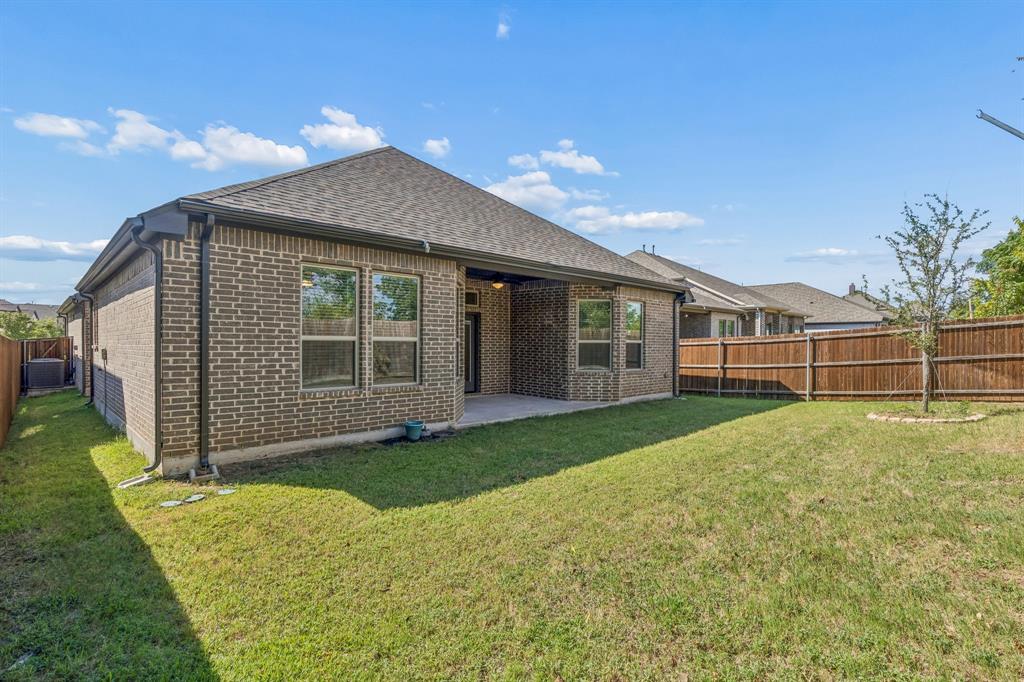 5224 Troupe Road McKinney, TX 75071 - Photo 26 of 31 Brick exterior home featuring a covered patio, fenced yard, and a young tree