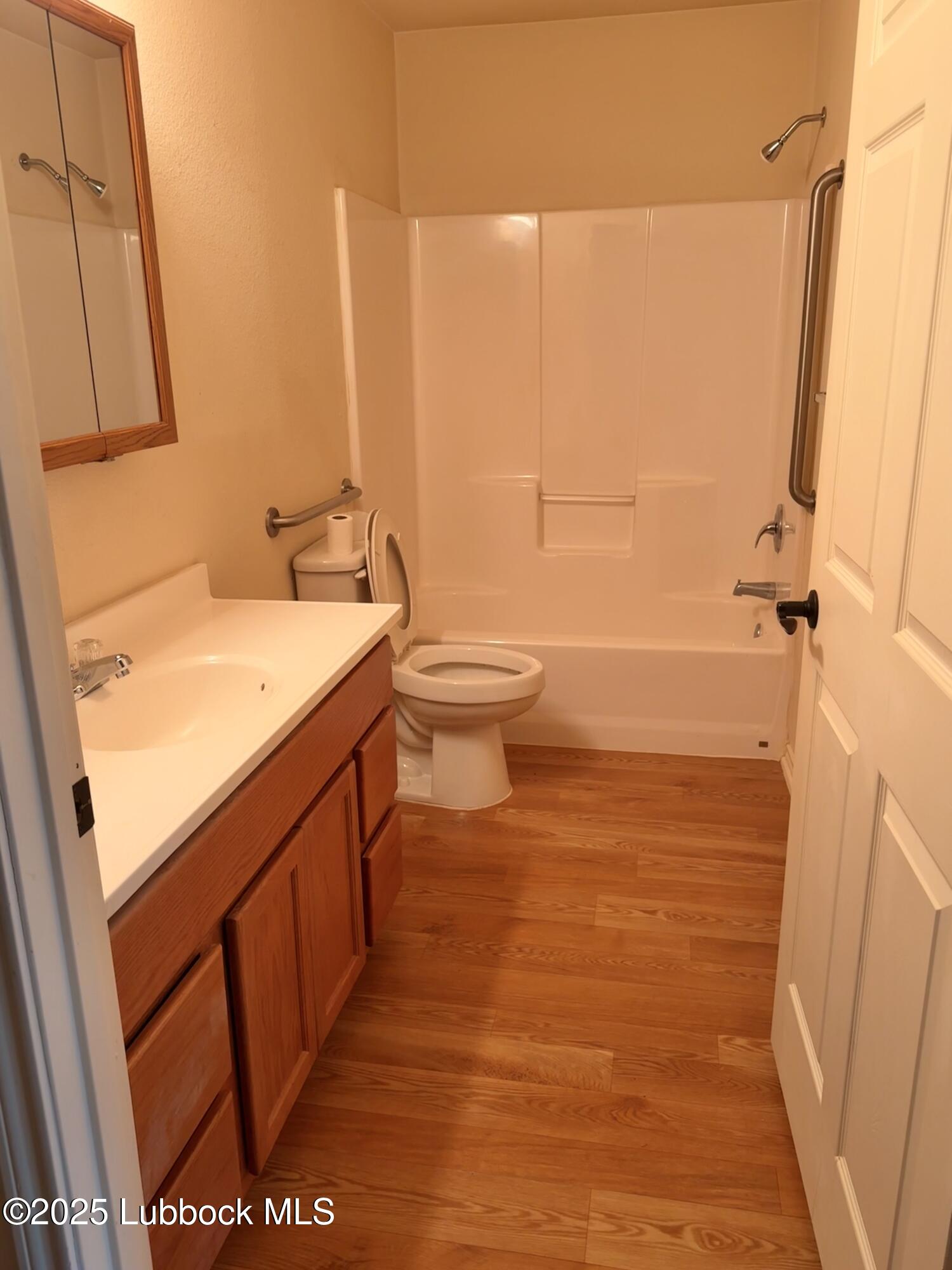 307 East 3rd Street Muleshoe, TX 79347 - Photo 12 of 20 a bathroom with a sink a toilet and shower