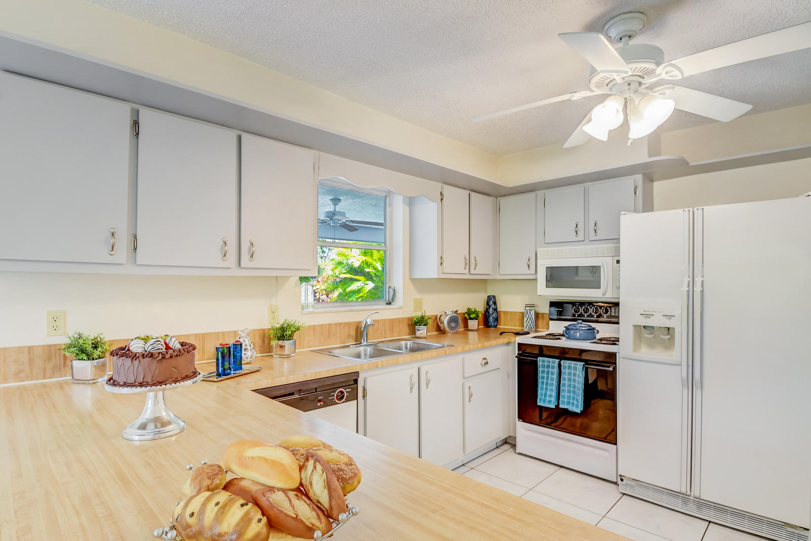 22298 Garrison Street Boca Raton, FL 33428 - Photo 23 of 62 a kitchen with stainless steel appliances granite countertop a refrigerator sink and white cabinets