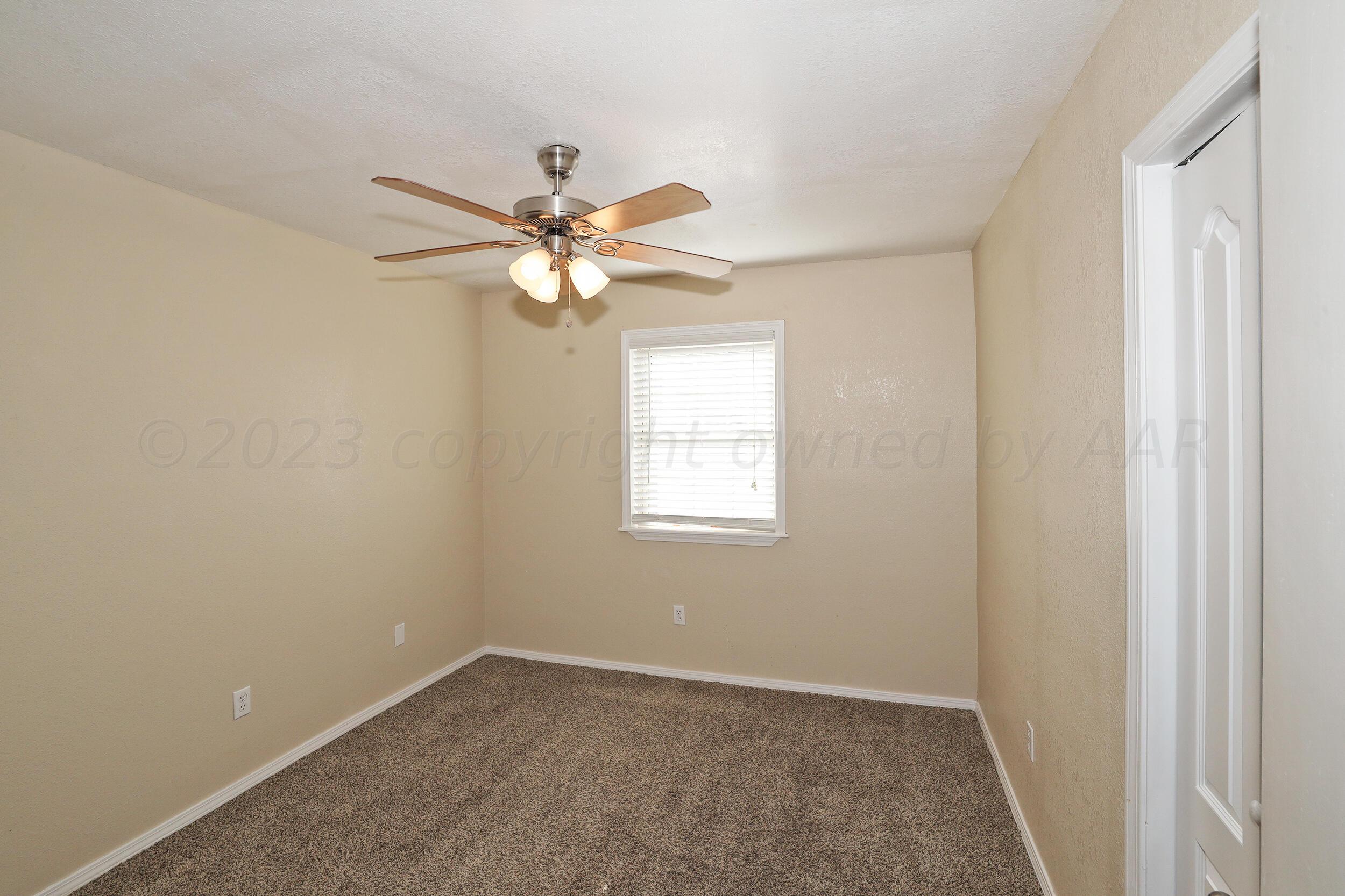 2905 Salem Drive Amarillo, TX 79110 - Photo 23 of 29 an empty room with a window and a fan
