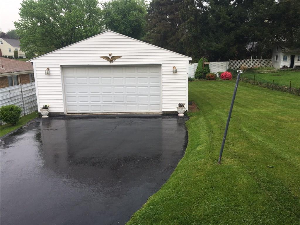 115 Lindsay Road Carnegie, PA 15106 - Photo 17 of 18 Large Level Drive Leads to oversized 2 Car Garage with extra storage. Beautiful level backyard perfect for outdoor fun and entertaining.