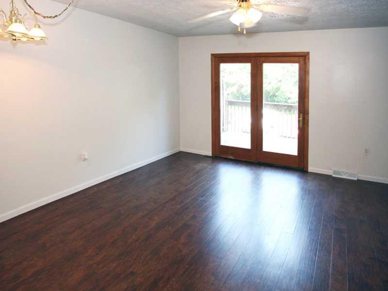 225 B Stone Quarry Road, Unit B Monaca, PA 15061 - Photo 5 of 11 Living Room. Great space for entertaining, nice view of the new hardwood floors. French doors lead out to the newly stained deck.