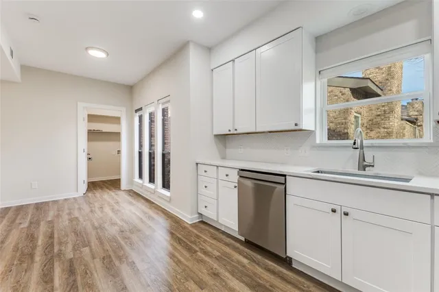 a kitchen with stainless steel appliances granite countertop a sink and cabinets