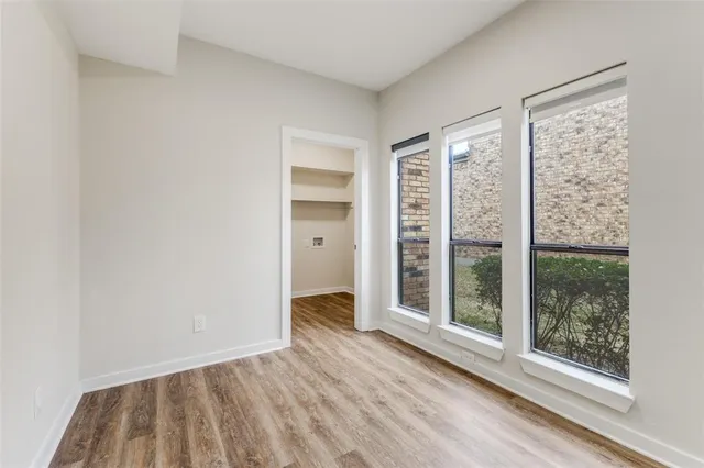 a view of wooden floor and windows in a room