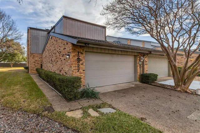 a view of a house with a wooden fence