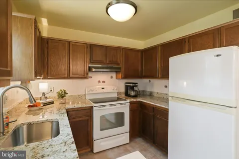 a kitchen with a sink a stove and refrigerator