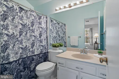 a bathroom with a sink toilet and a mirror
