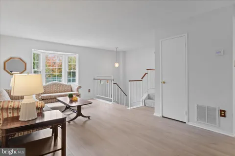 a dining room with furniture a potted plant and a chandelier