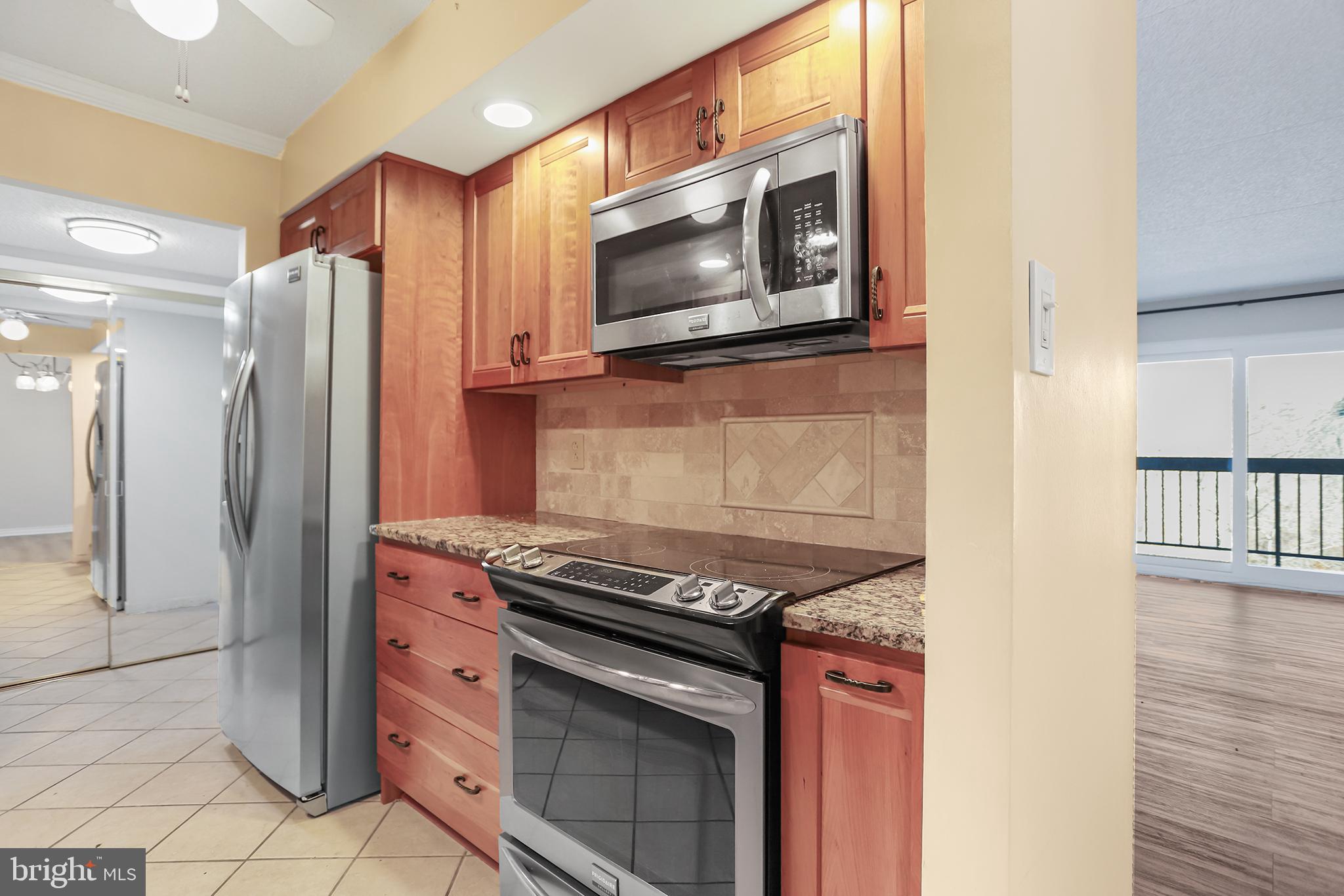 800 Avondale Road, Unit 6J Wallingford, PA 19086 - Photo 10 of 28 Modern kitchen with warm wood accents.