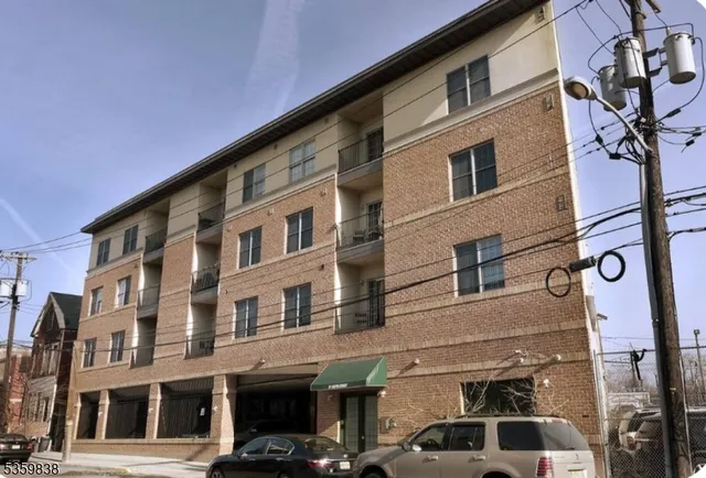 a front view of a building with parking space