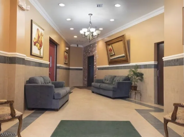 a living room with furniture and a chandelier