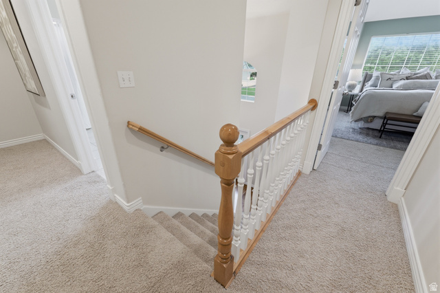 1888 East Cobblestone Road Springville, UT 84663 - Photo 24 of 44 Carpeted hallway and staircase featuring light wood-finish railings, white balusters, and painted walls
