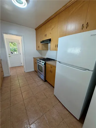 a kitchen with granite countertop a refrigerator and a stove
