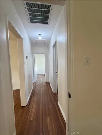 a view of hallway with wooden floor