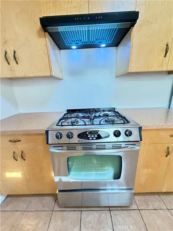 a stove top oven sitting inside of a kitchen