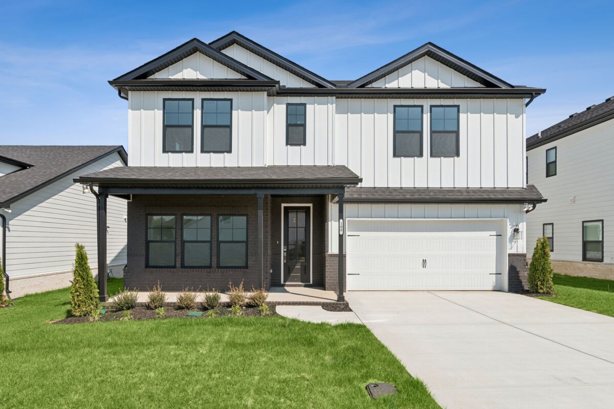 a front view of a house with a yard and garage