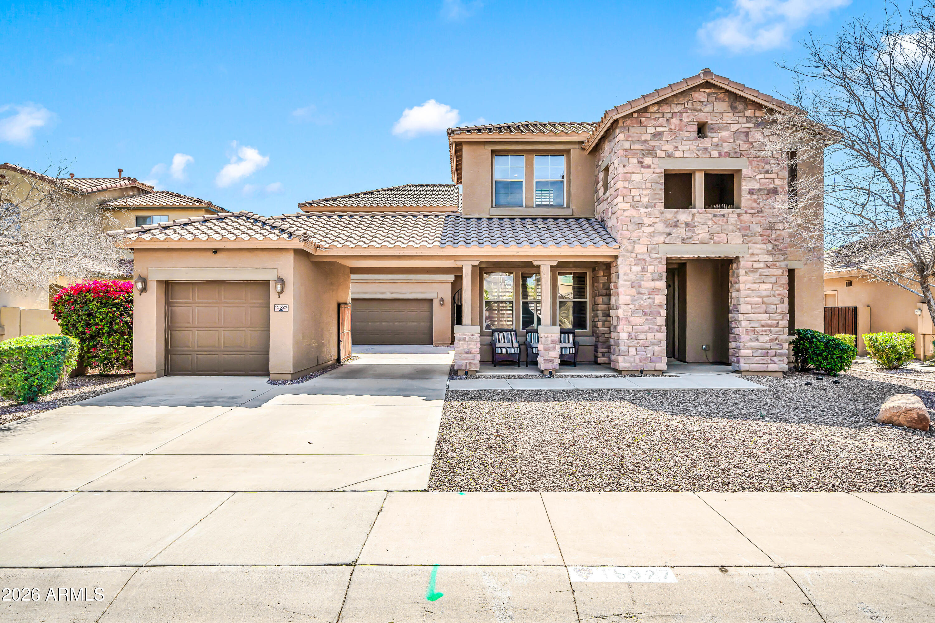front view of a brick house with a yard