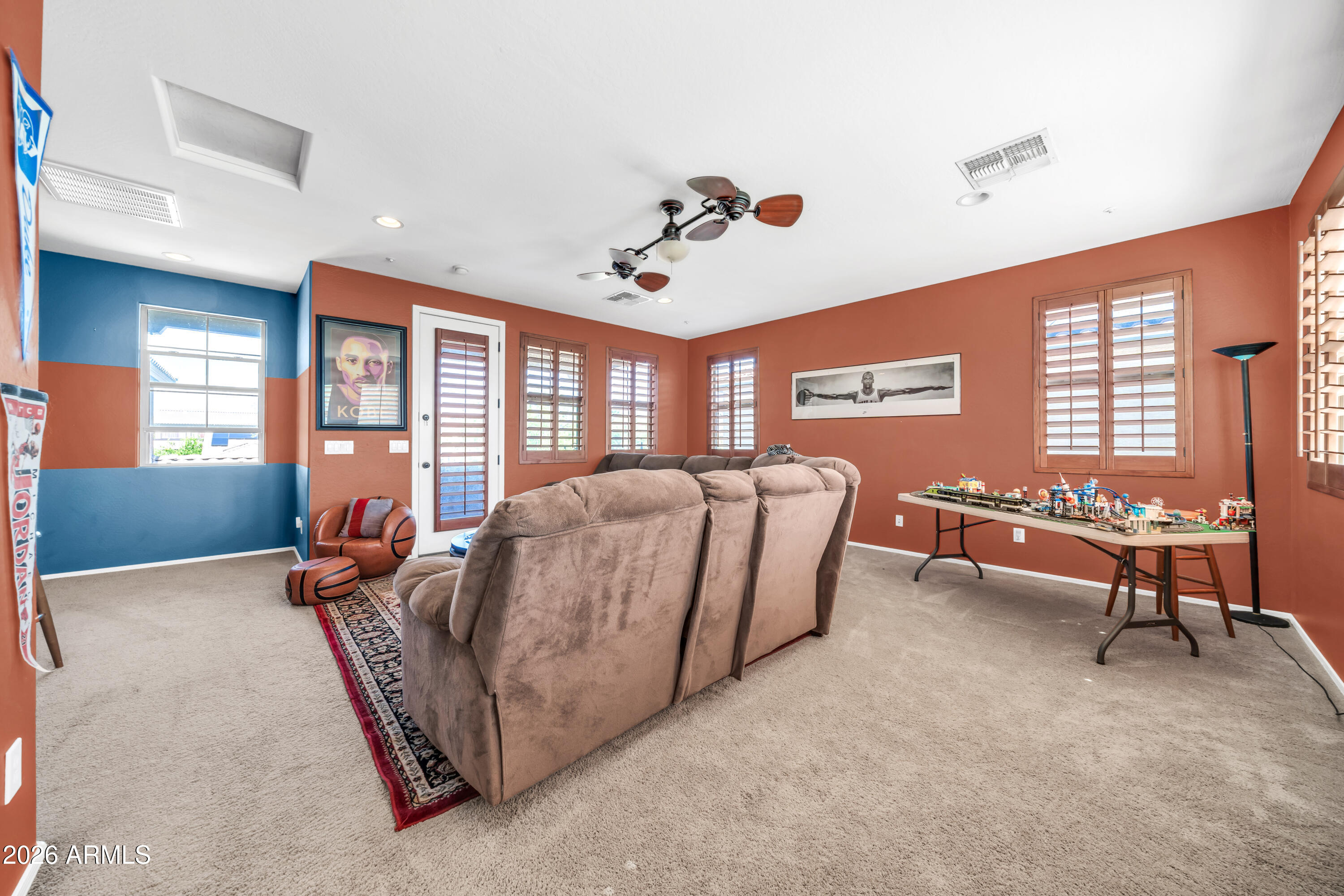 15327 West Roma Avenue Goodyear, AZ 85395 - Photo 10 of 65 a living room with furniture a flat screen tv and windows