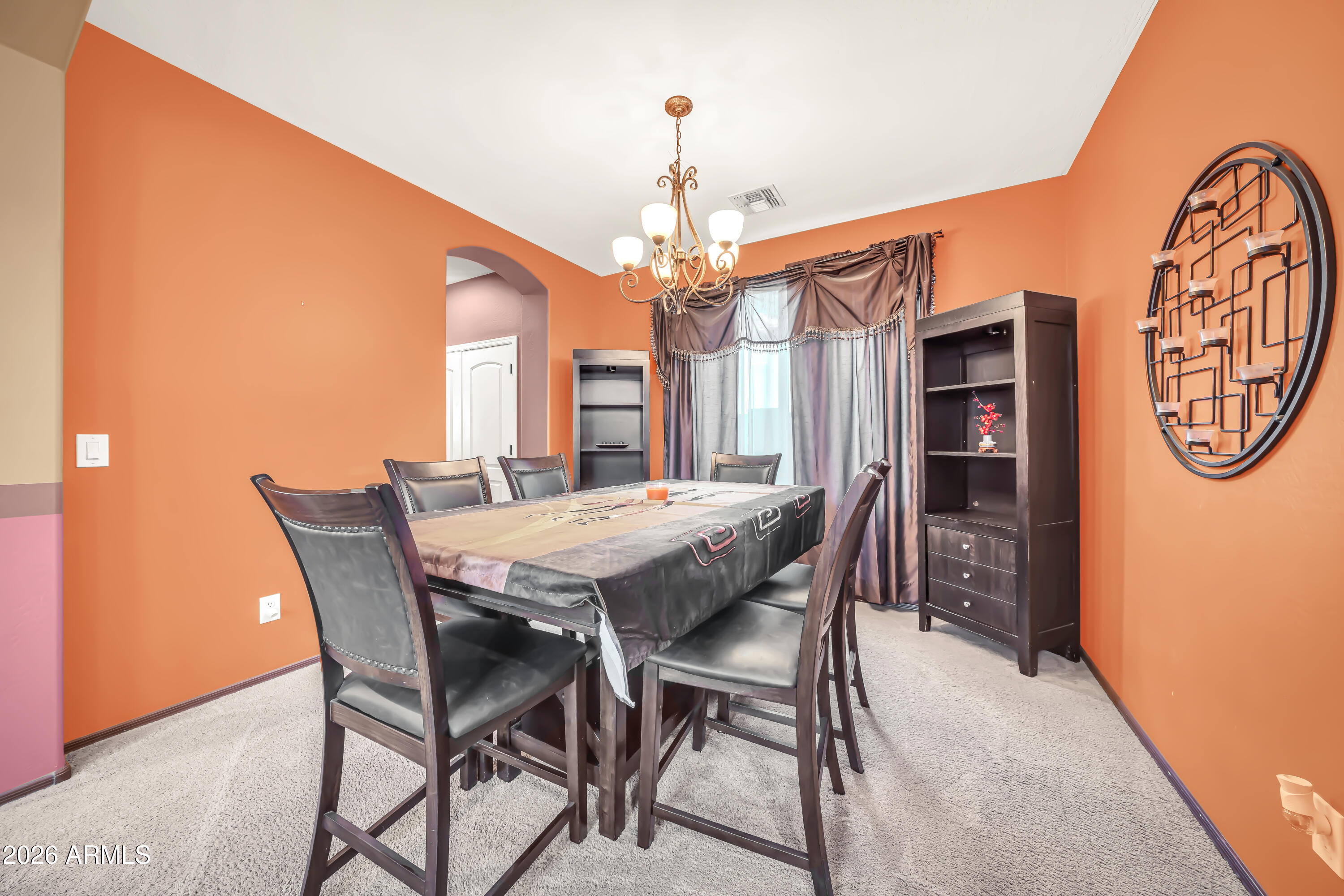 15327 West Roma Avenue Goodyear, AZ 85395 - Photo 17 of 65 a view of a dining room with furniture and a chandelier