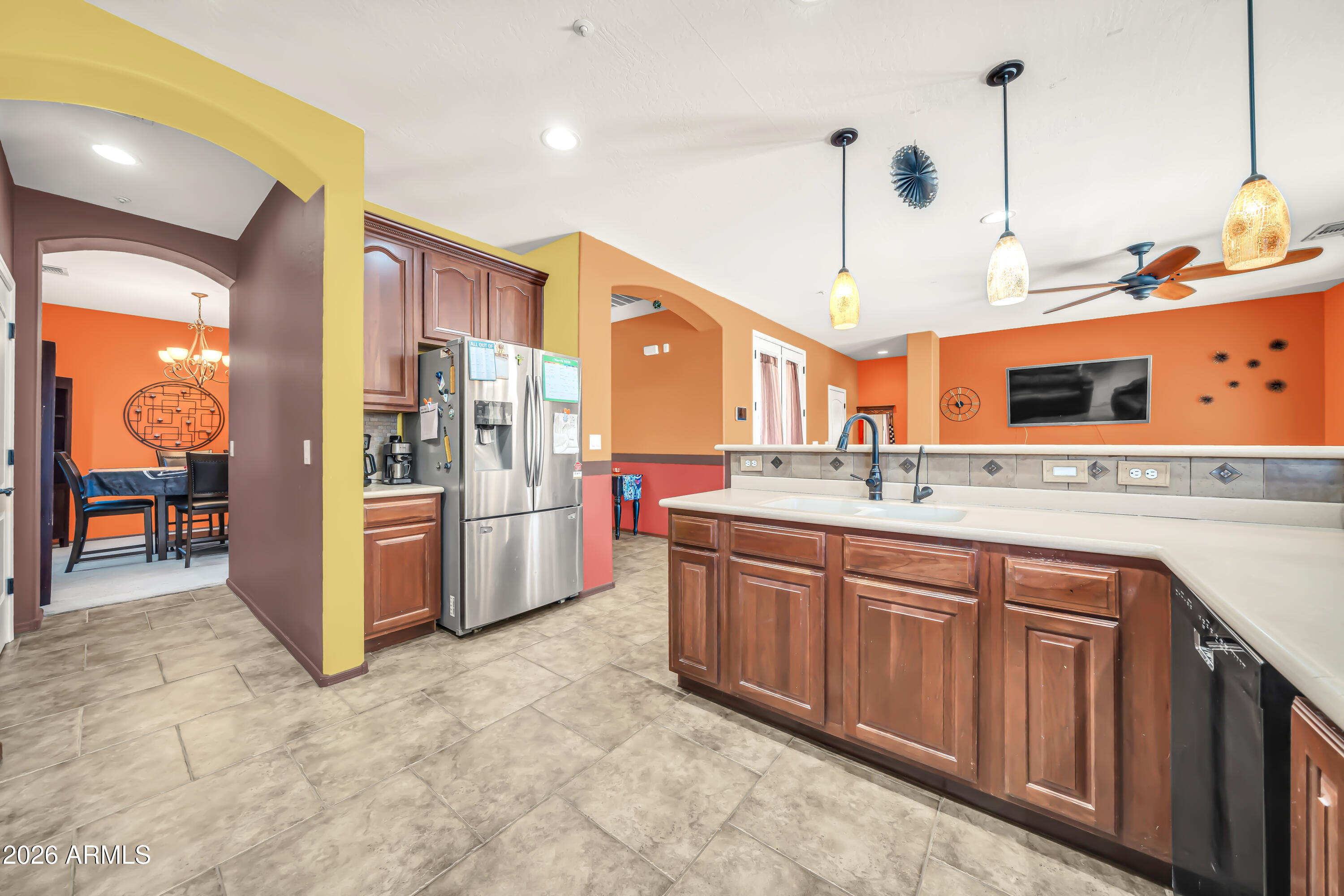 15327 West Roma Avenue Goodyear, AZ 85395 - Photo 19 of 65 a kitchen with stainless steel appliances a sink and a refrigerator