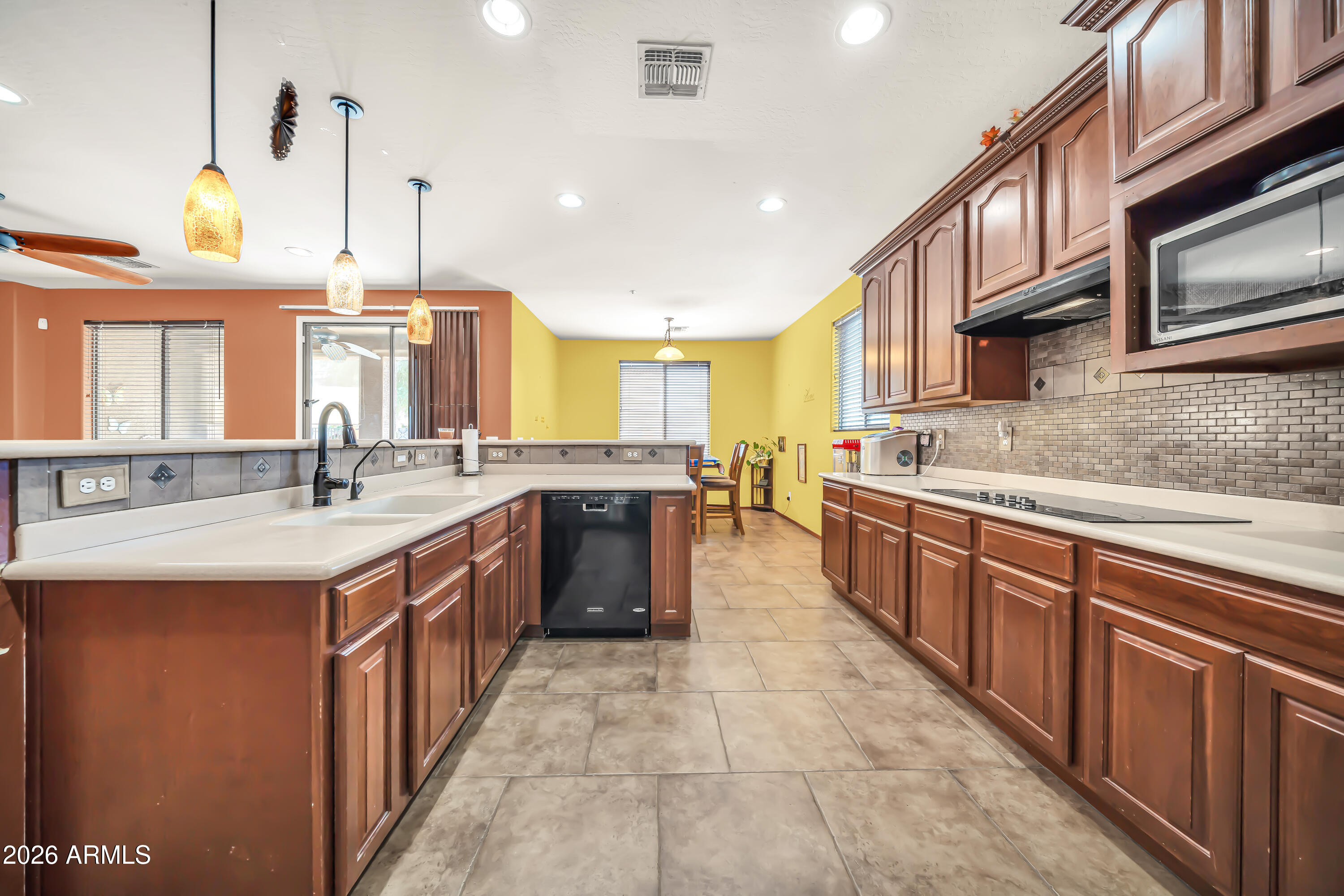 15327 West Roma Avenue Goodyear, AZ 85395 - Photo 22 of 65 a large kitchen with stainless steel appliances and a sink