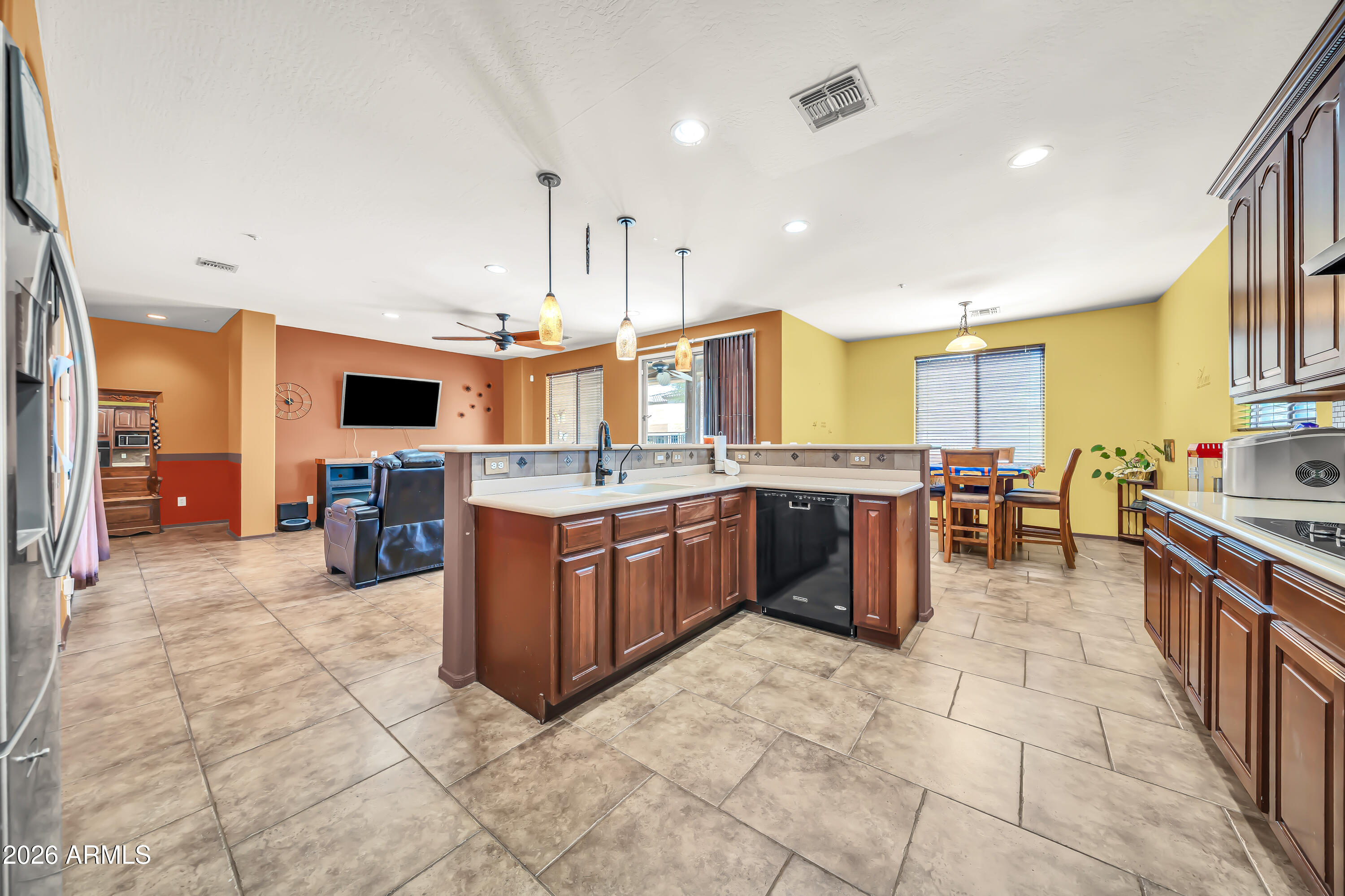 15327 West Roma Avenue Goodyear, AZ 85395 - Photo 23 of 65 a large kitchen with a large counter top appliances and cabinets