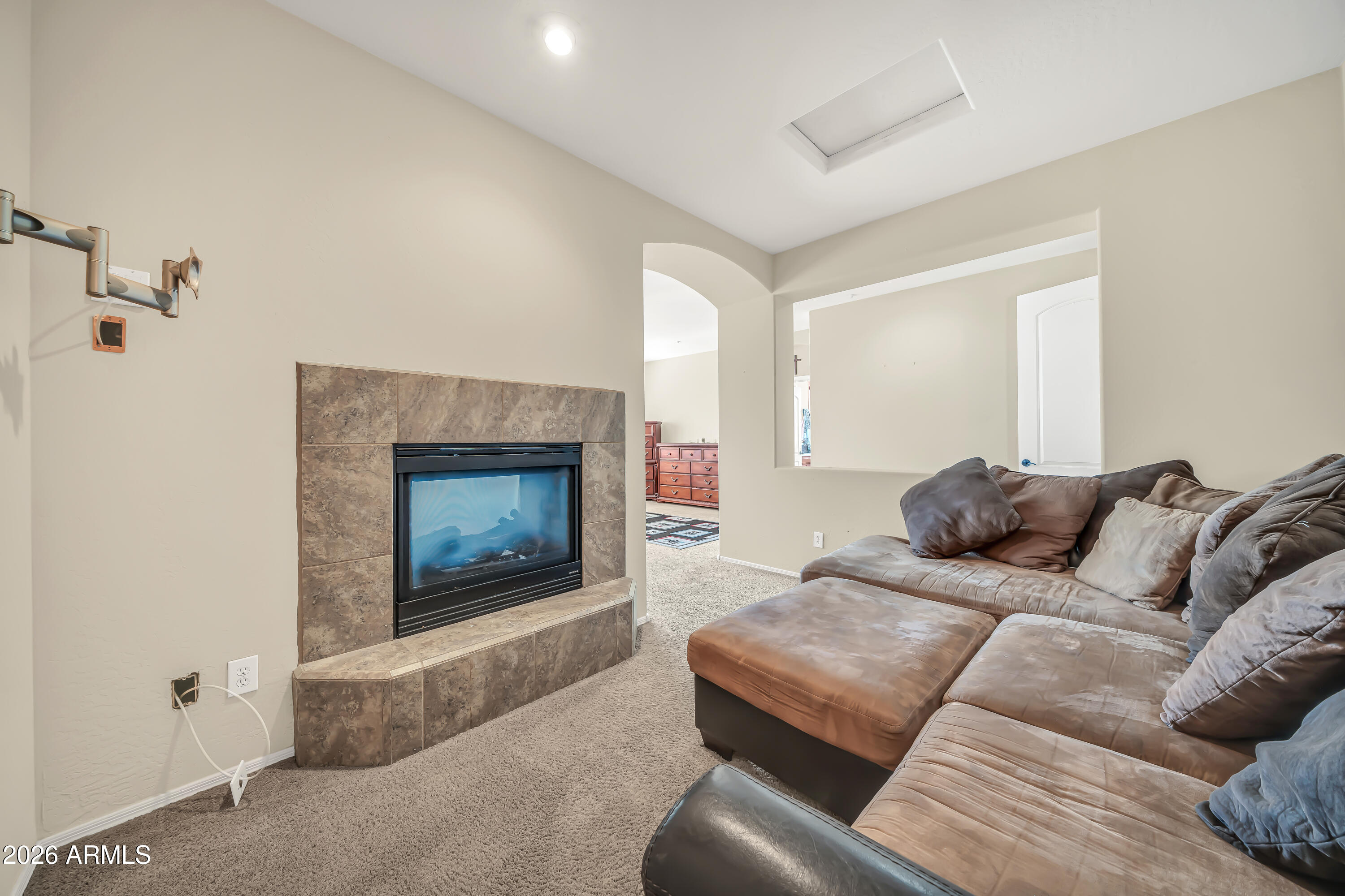 15327 West Roma Avenue Goodyear, AZ 85395 - Photo 31 of 65 a living room with furniture and a fireplace
