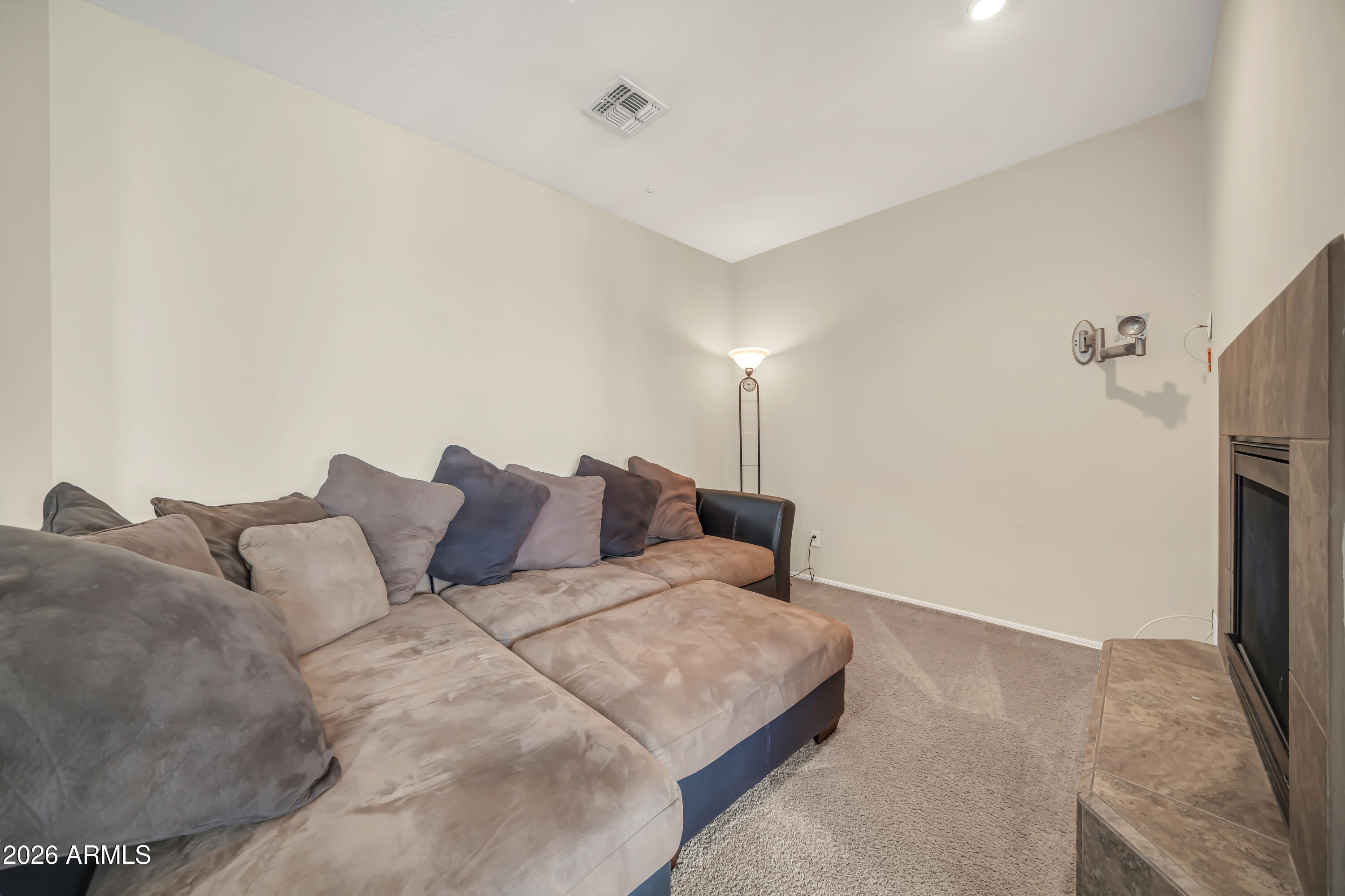 15327 West Roma Avenue Goodyear, AZ 85395 - Photo 32 of 65 a large bedroom with a bed and a refrigerator