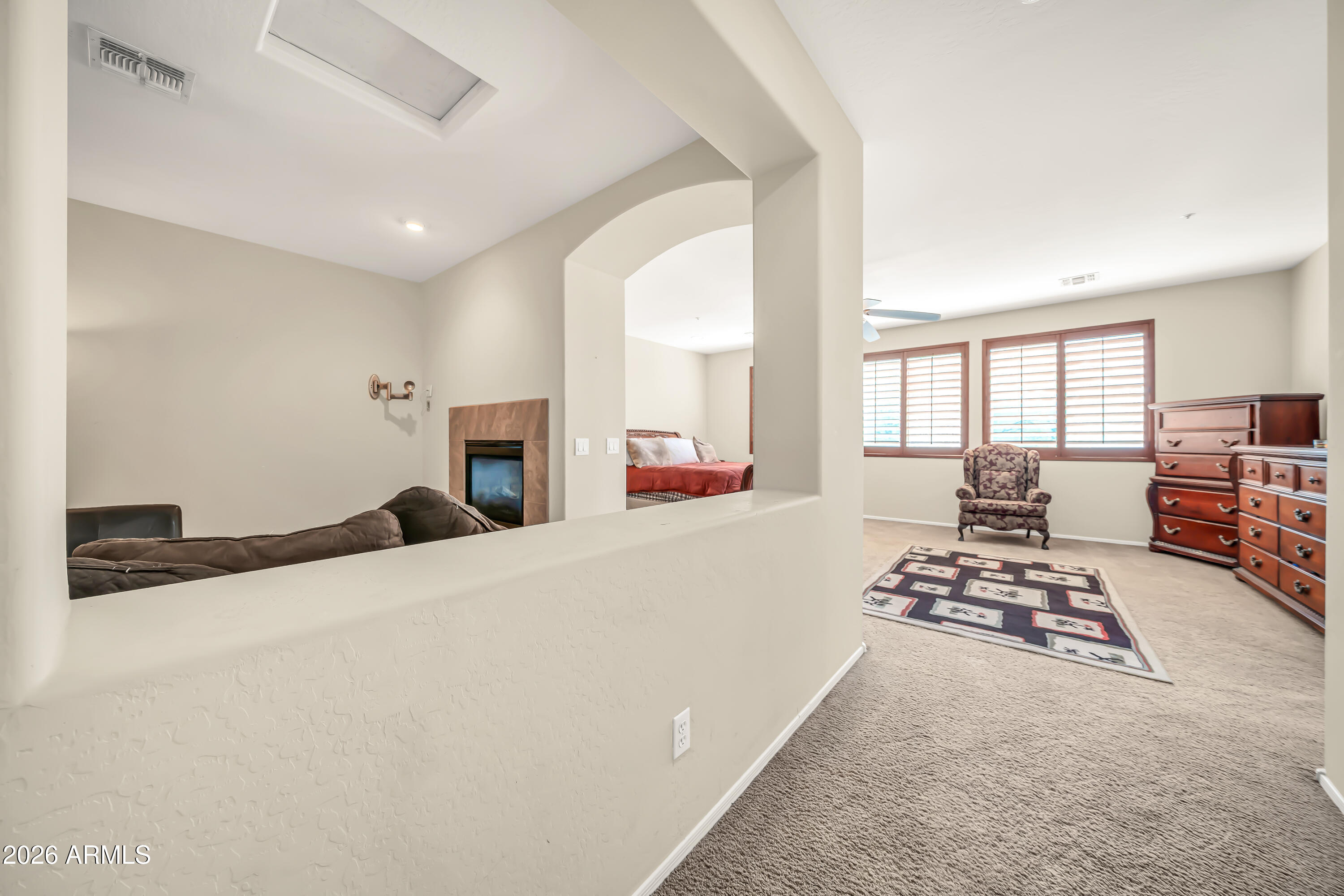 15327 West Roma Avenue Goodyear, AZ 85395 - Photo 33 of 65 a bedroom with furniture and a fireplace