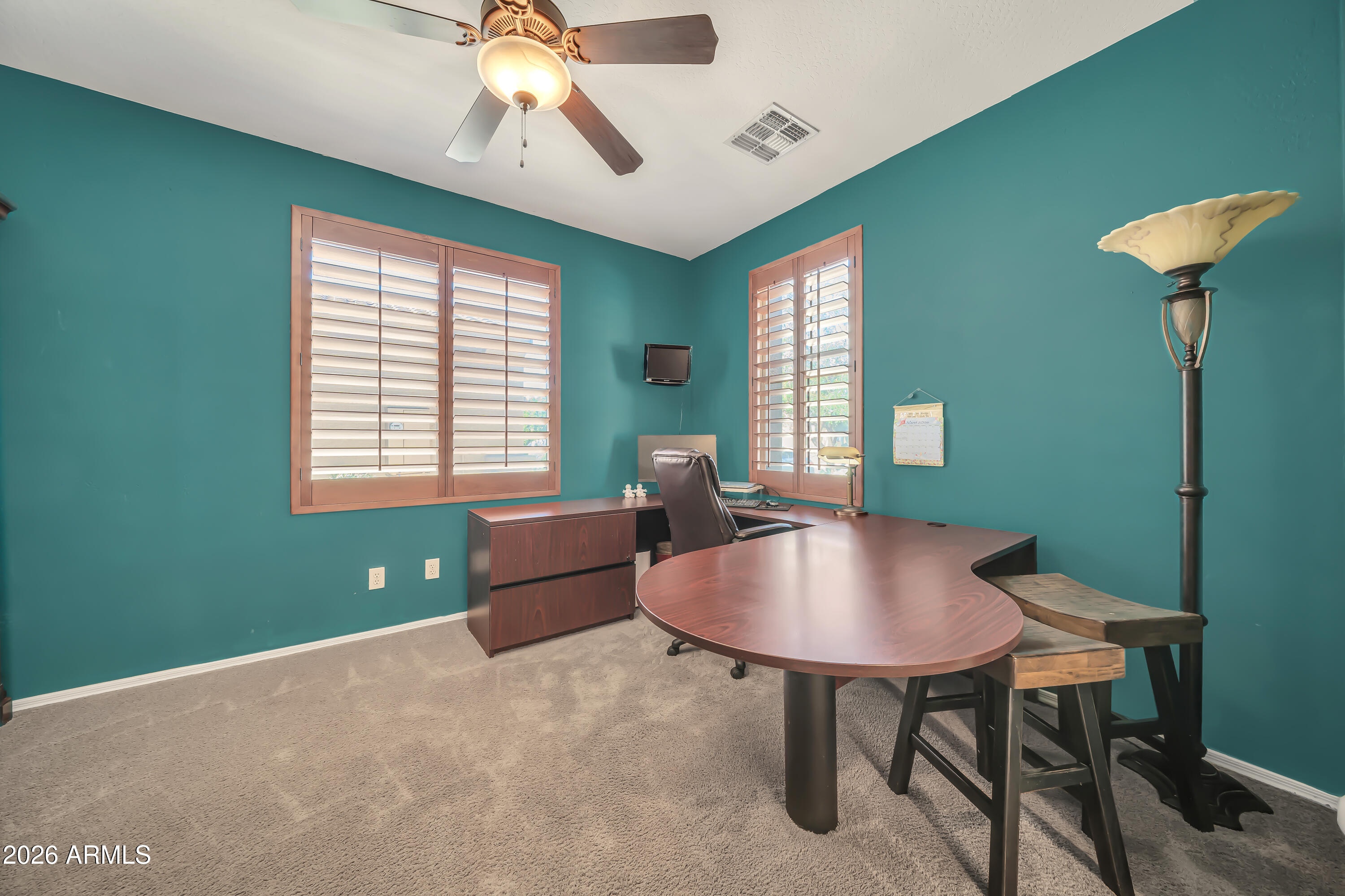 15327 West Roma Avenue Goodyear, AZ 85395 - Photo 35 of 65 a living room with furniture and a window
