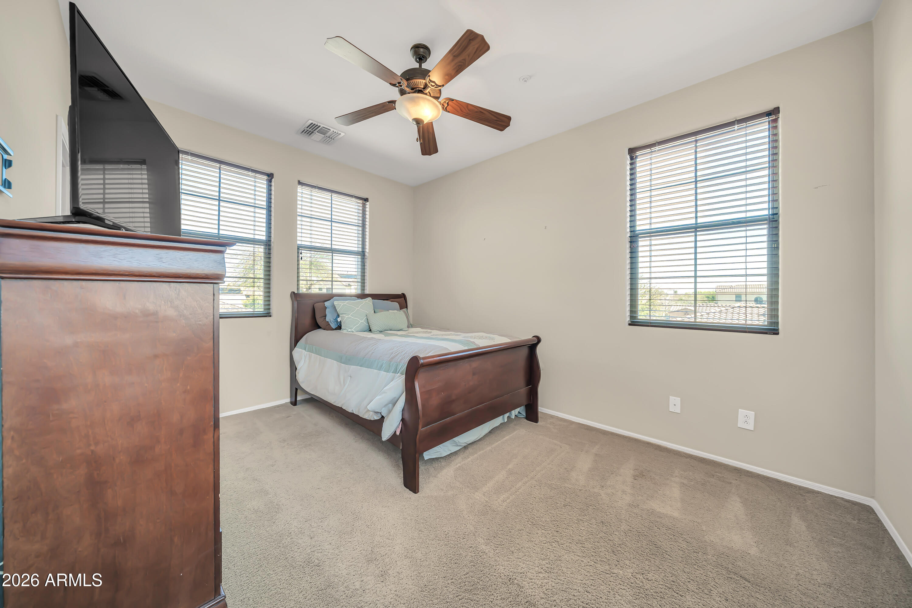 15327 West Roma Avenue Goodyear, AZ 85395 - Photo 41 of 65 a spacious bedroom with a bed a window and closet
