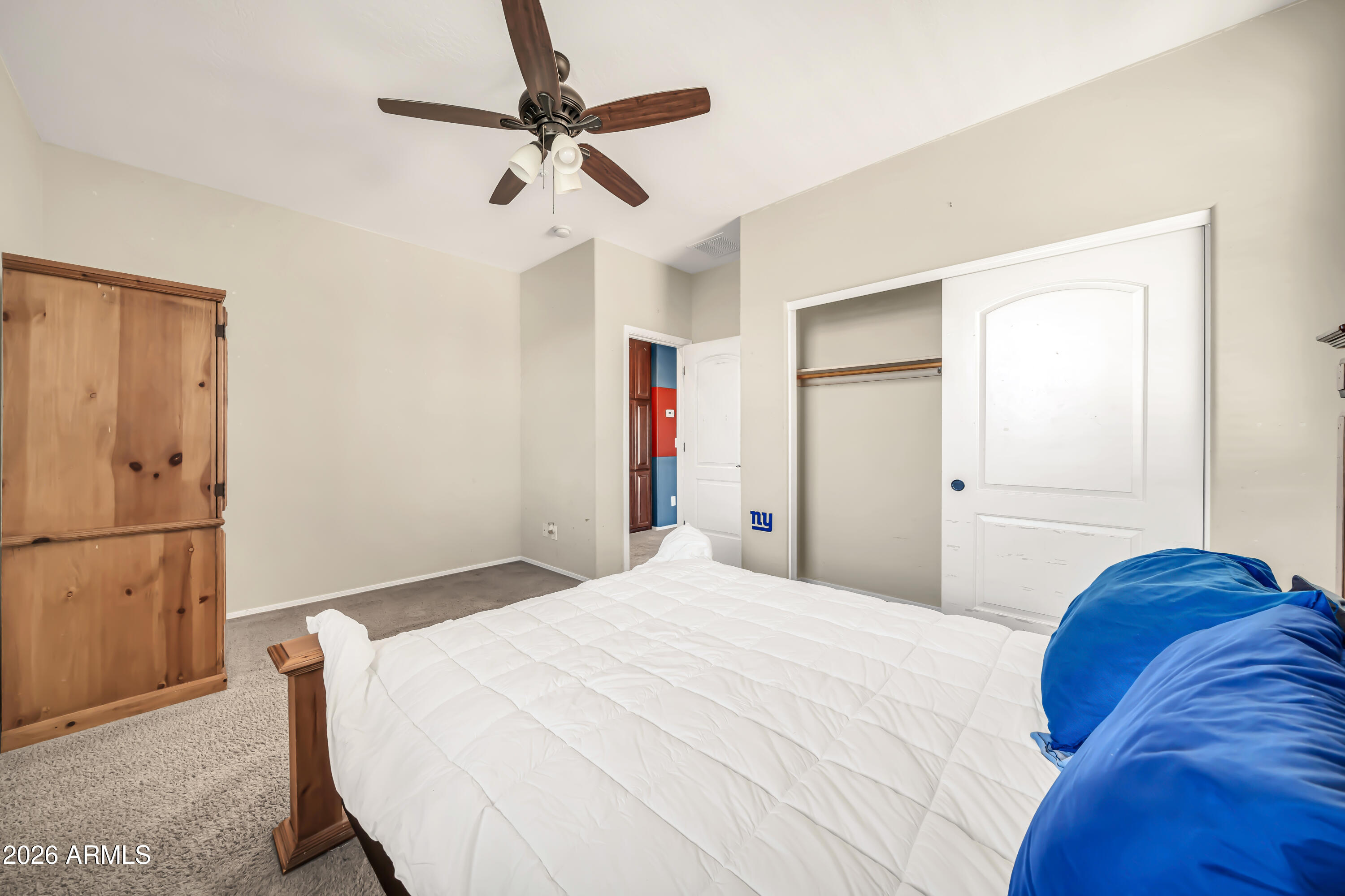 15327 West Roma Avenue Goodyear, AZ 85395 - Photo 42 of 65 a bedroom with a bed and a ceiling fan