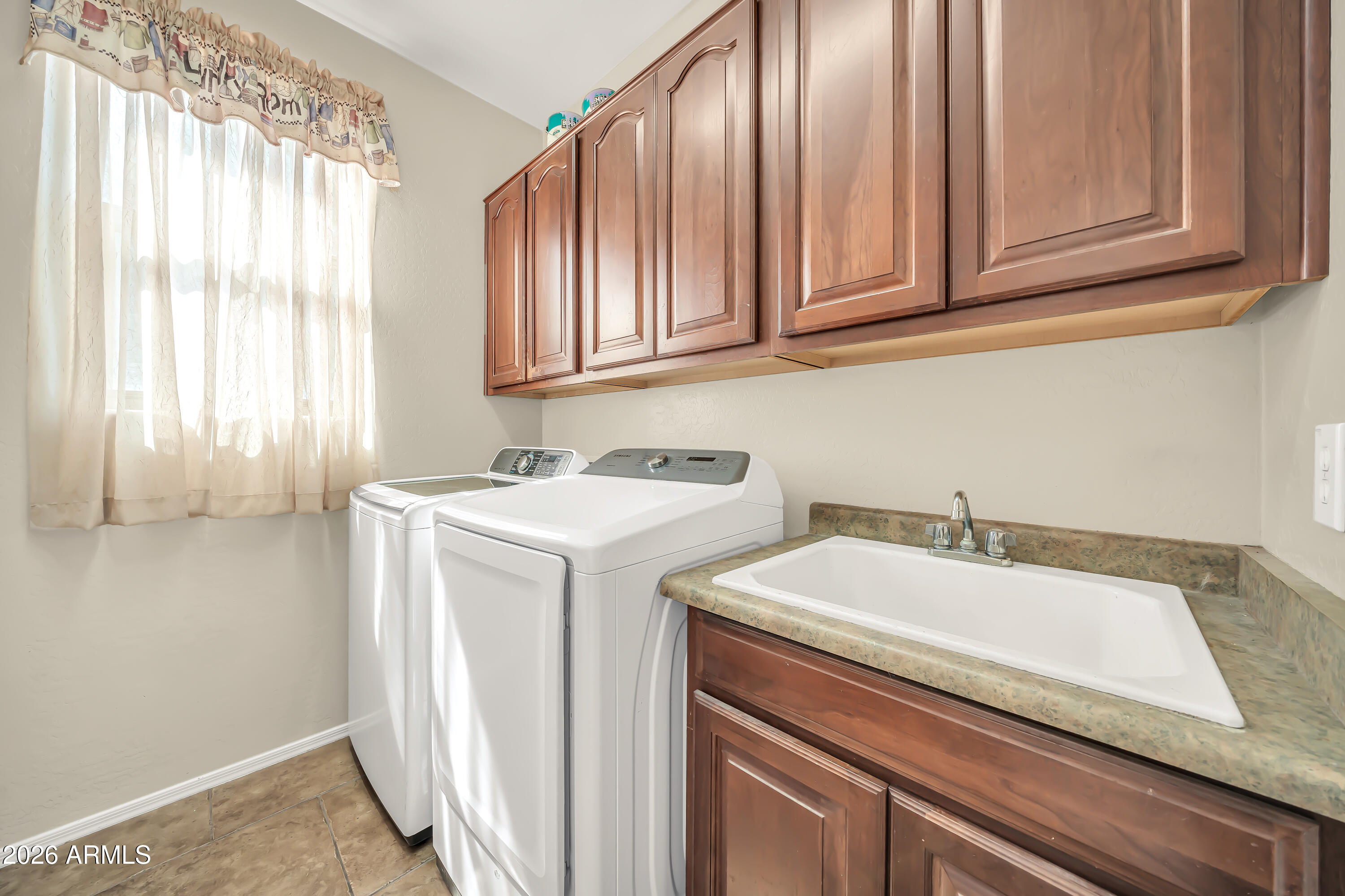 15327 West Roma Avenue Goodyear, AZ 85395 - Photo 45 of 65 a utility room with a sink washer and dryer