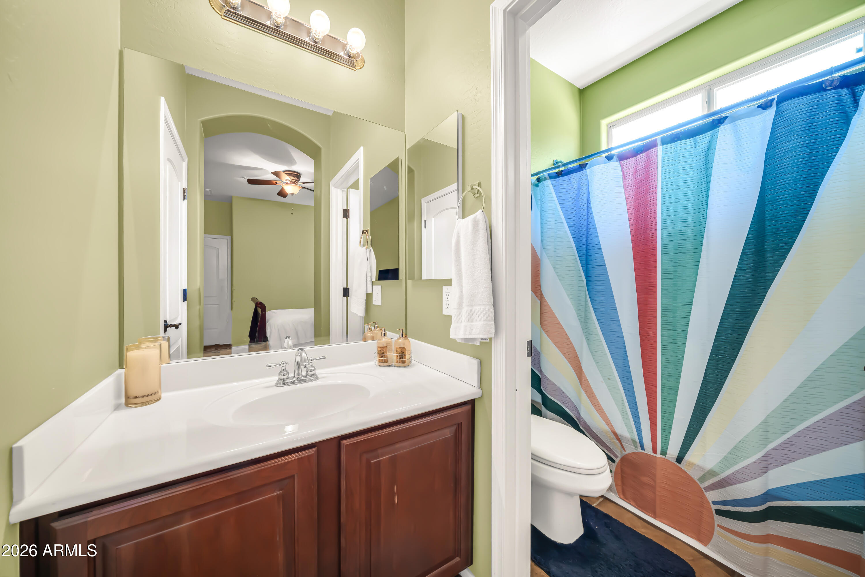 15327 West Roma Avenue Goodyear, AZ 85395 - Photo 46 of 65 a bathroom with a sink a toilet and a mirror