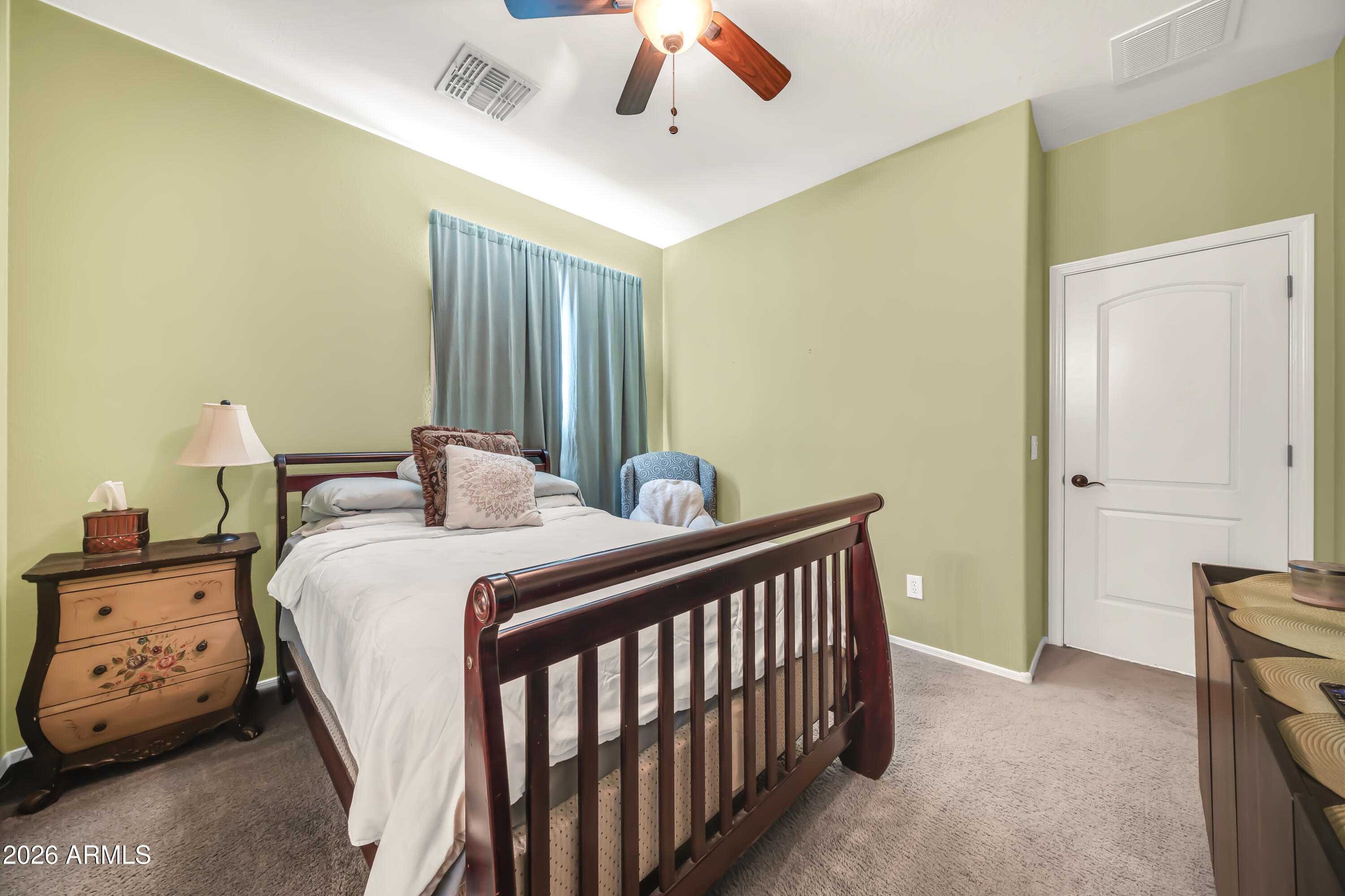 15327 West Roma Avenue Goodyear, AZ 85395 - Photo 47 of 65 a bedroom with a bed and a chandelier