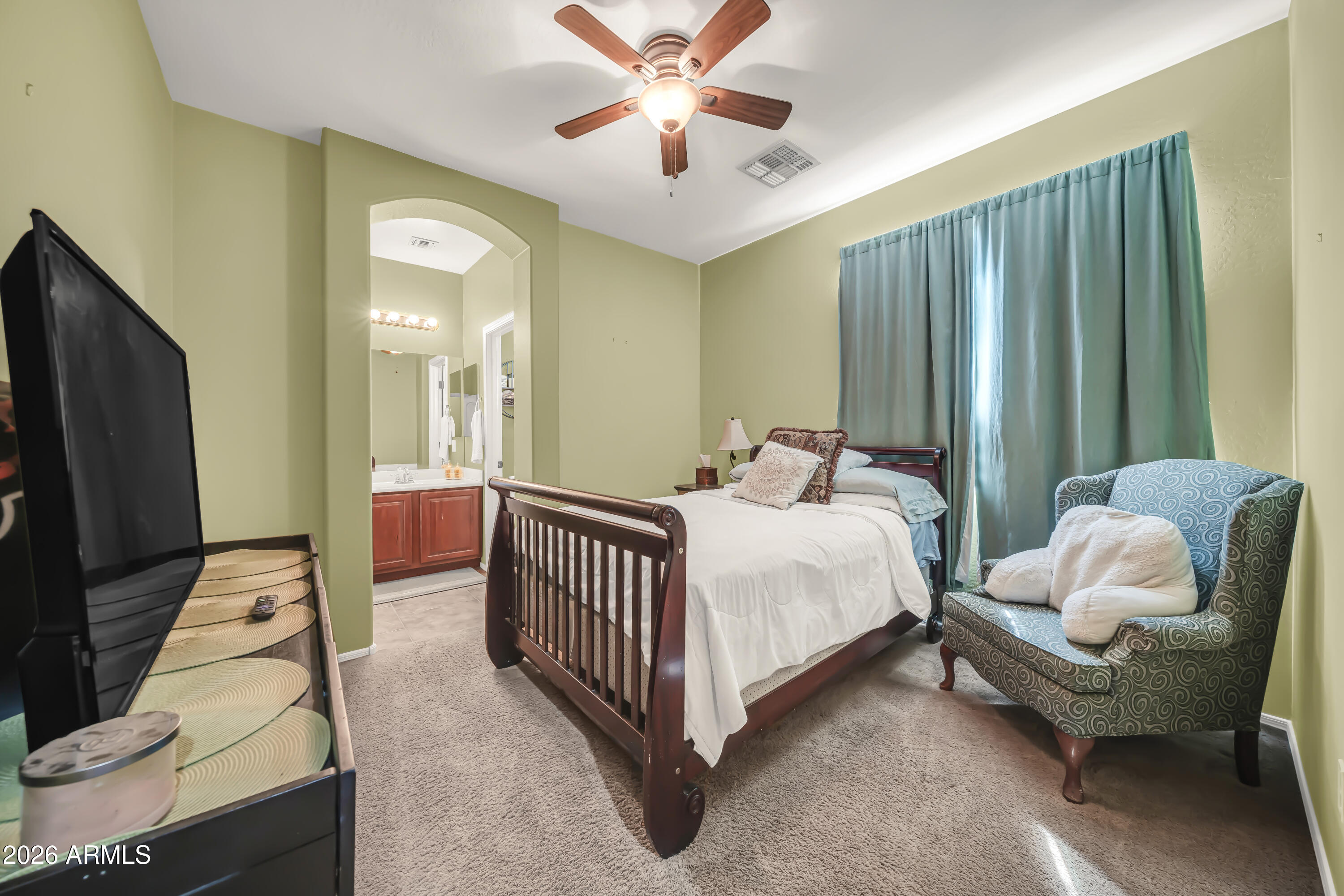 15327 West Roma Avenue Goodyear, AZ 85395 - Photo 48 of 65 a bedroom with a bed and a chandelier