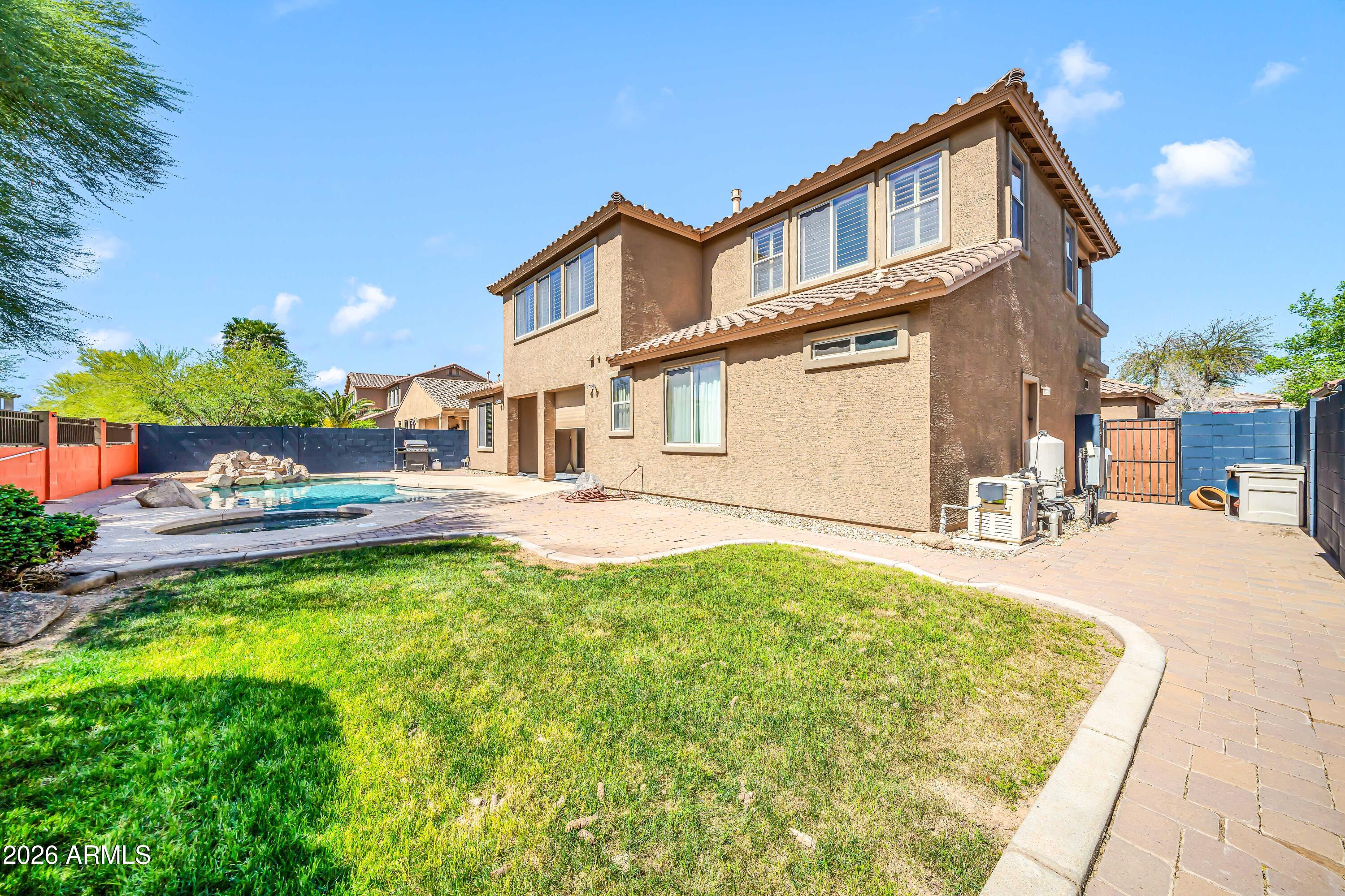 15327 West Roma Avenue Goodyear, AZ 85395 - Photo 52 of 65 a front view of a house with a yard