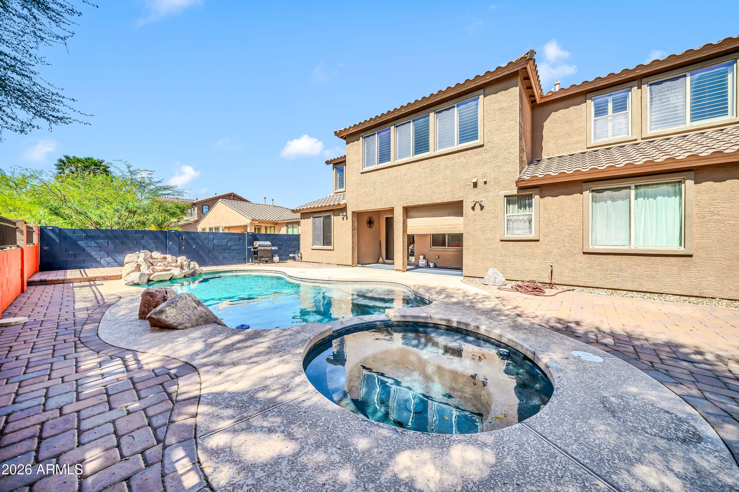 15327 West Roma Avenue Goodyear, AZ 85395 - Photo 56 of 65 a front view of a house with a yard and potted plants