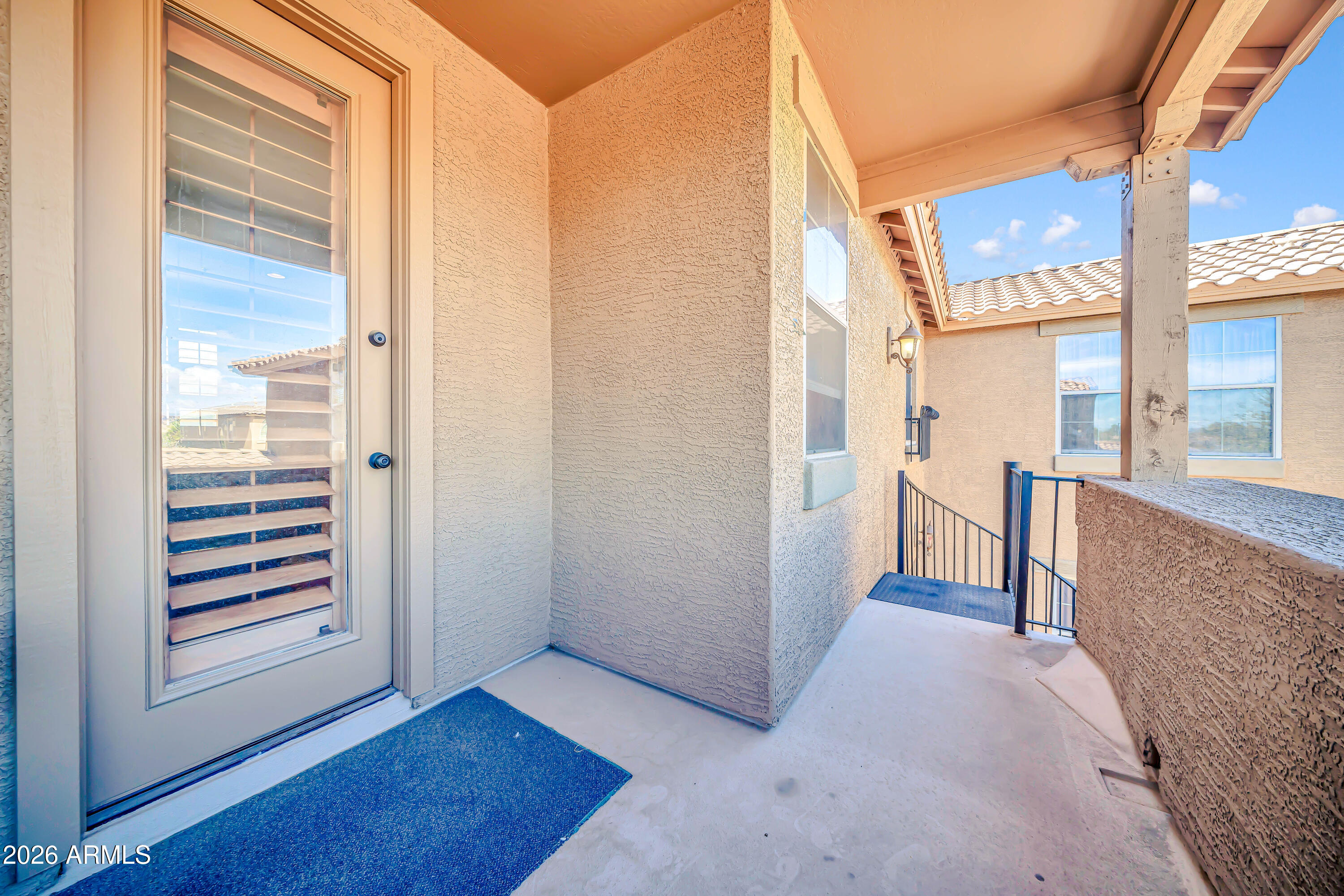 15327 West Roma Avenue Goodyear, AZ 85395 - Photo 61 of 65 a view of a hallway with wooden floor and a bathroom