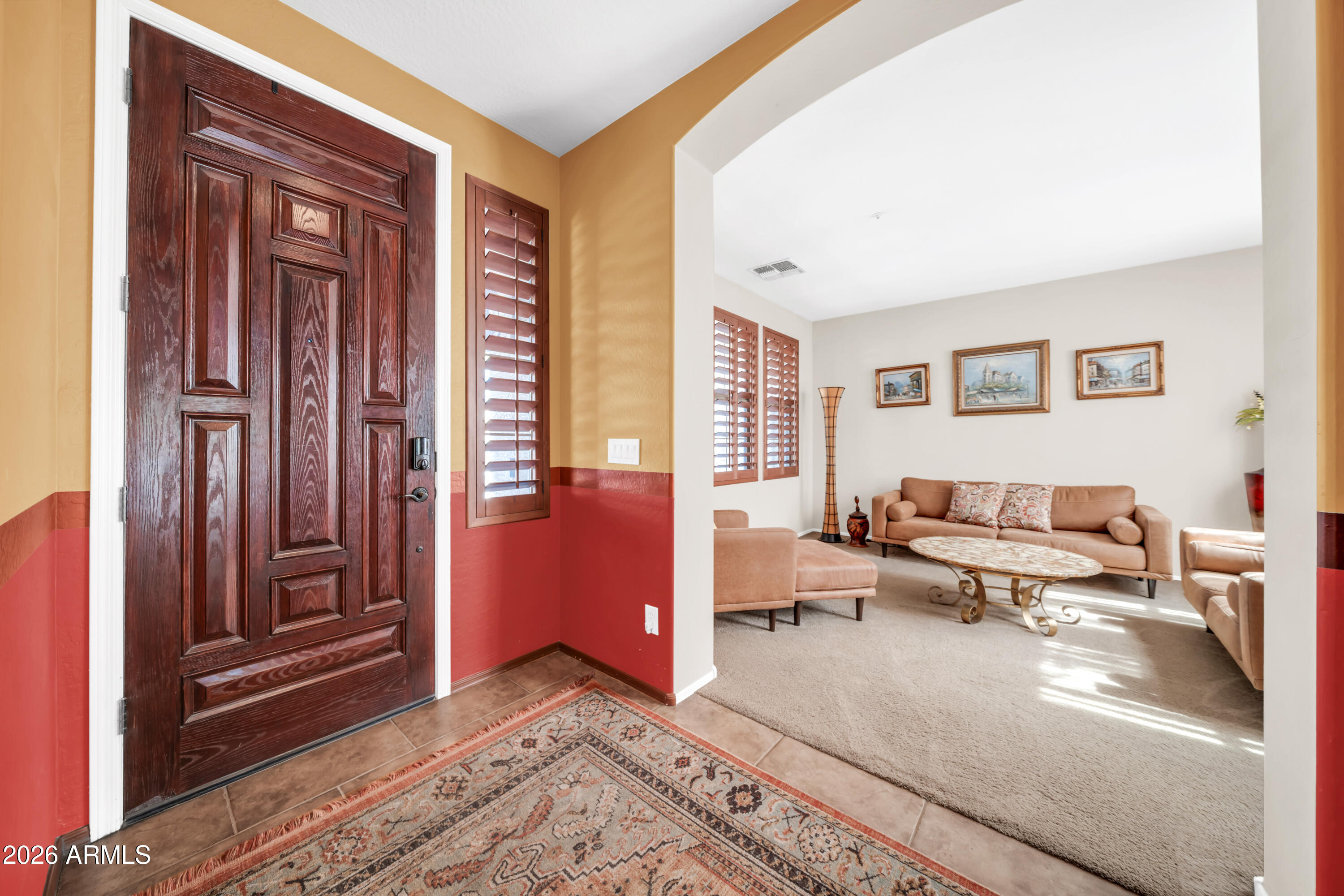 15327 West Roma Avenue Goodyear, AZ 85395 - Photo 5 of 65 a living room with furniture and a window