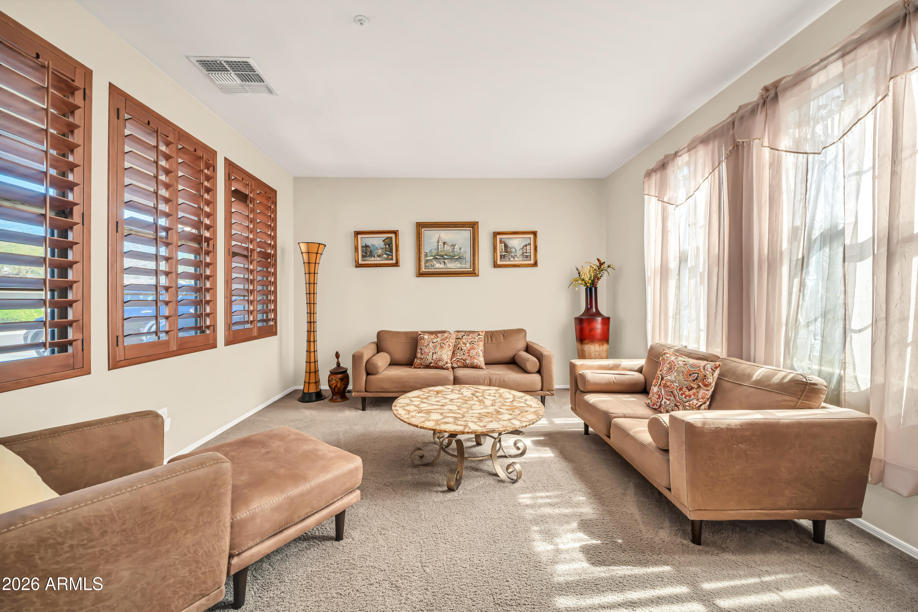 15327 West Roma Avenue Goodyear, AZ 85395 - Photo 7 of 65 a living room with furniture and a large window