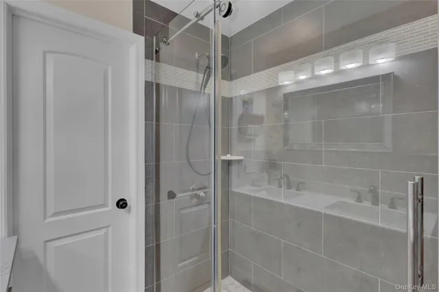 a bathroom with a shower and a sink