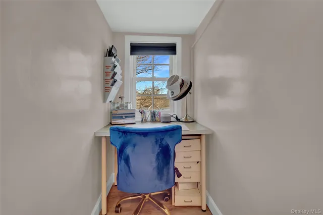 a view of workspace with a table and chair