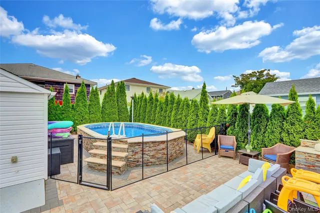 a view of a patio with a table and chairs under an umbrella