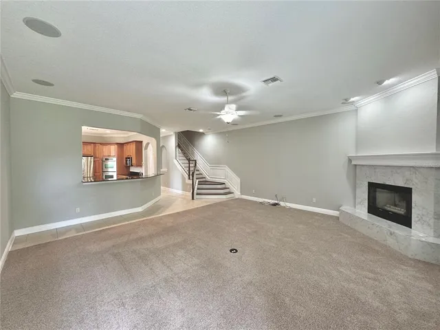 an empty room with windows and fireplace