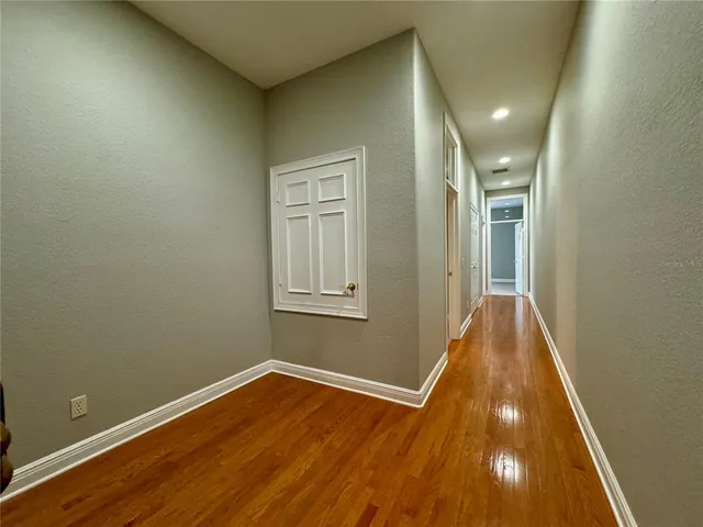a view of an empty room with a fireplace and a window